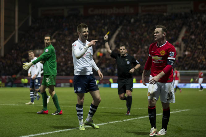 Preston's Paul Gallagher (centre left) remonstrates with Manchester United's Wayne Rooney after the latter wins a controversial penalty during the English FA Cup Fifth Round soccer match between Preston and Manchester United at Deepdale Stadium in Prest