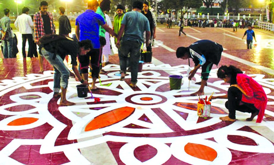PREPARATION AFOOT: Students of the Institute of Fine Arts painting 'Alpana' on the premises of Central Shaheed Minar marking the Amar Ekushey February. This photo was taken on Thursday.