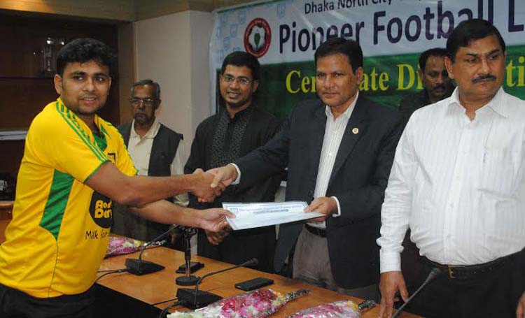 Vice-President of Bangladesh Football Federation (BFF) Badal Roy giving away the certificates to the coaches of the clubs of the Pioneer Football League at the BFF House on Friday.