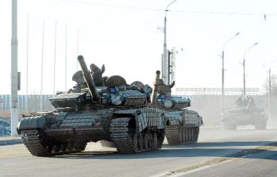 Pro-Russian separatists ride tanks in the Ukrainian city of Lugansk on Saturday.