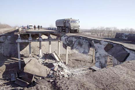 A truck belonging to the separatist self-proclaimed Donetsk People's Republic army moves over a partially destroyed bridge in the town of Debaltseve on Sunday.