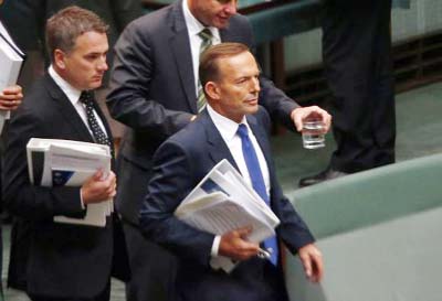 Australia's Prime Minister Tony Abbott (front) walks into the Australian Parliament located in the Australian capital city of Canberra on Monday.