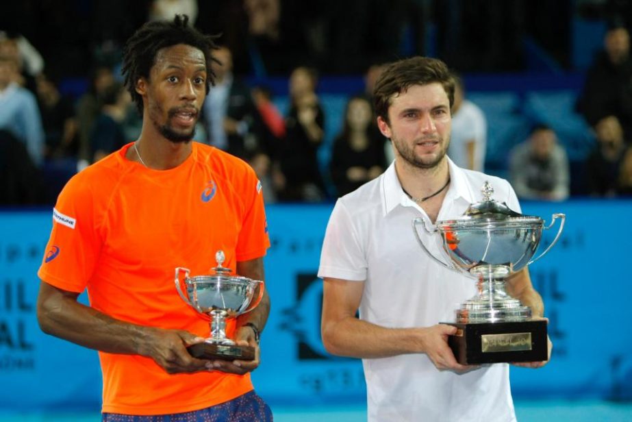 France's Gilles Simon (right) and France's Gael Monfils, hold their trophies, after Simon winning their final match at the Open 13 tennis tournament in Marseille, southern France on Sunday.