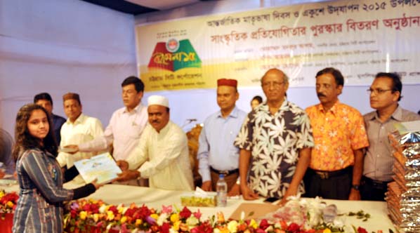 Panel Mayor Lion Mohammad Hossain distributing certificate among the winners of cultural competition arranged in observance of the Amar Ekushey at Muslim institute in the city on Saturday.