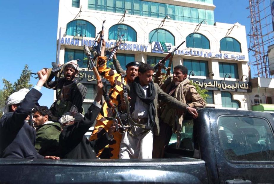 Shiite Huthi fighters shout slogans as they drive in a the back of a vehicle in the Yemeni capital Sanaa.