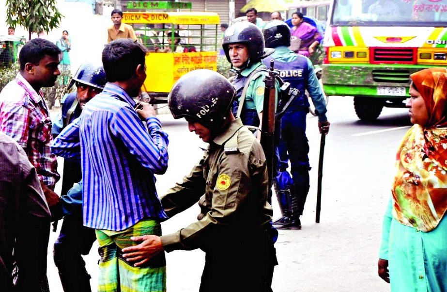 Law enforcers checking pedestrians for security reasons as arrest warrant was issued against BNP Chairperson Begum Khaleda Zia on two corruption cases. The snap was taken from the city's Motijheel area on Wednesday.