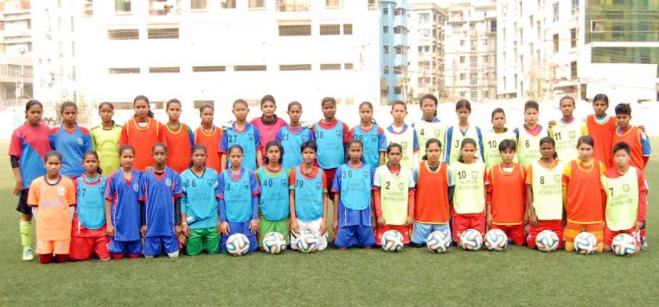 The members of Bangladesh Under-14 Women's Football team pose for photograph at the BFF Artificial Turf on Thursday.