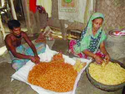 Abul Hossain and his wife making dry food.