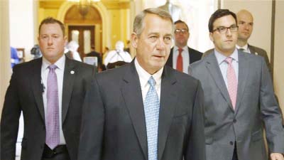 US House Speaker John Boehner (R-OH) Â© walks to the House floor for procedural votes for legislation to fund the Department of Homeland Security at the Capitol in Washington on Friday.