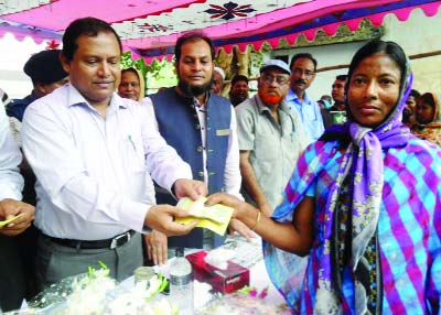 MELANDOAH(Jamalpur): State Minister for Textile and Jute Mirza Azam MP distributing money among VGD cardholders women in Melandoah Upazila recently.