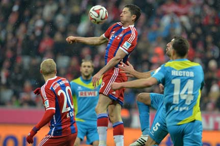 Bayern's Robert Lewandowski from Poland (center) goes for a header during the soccer match between FC Bayern Munich and FC Cologne at the Allianz Arena in Munich, Germany on Friday.