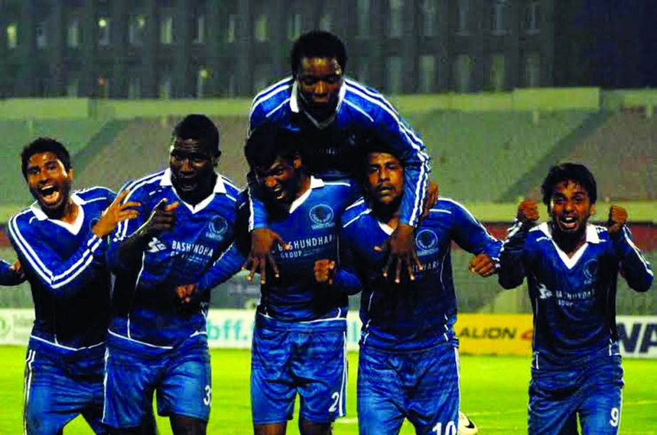 Players of Sheikh Jamal Dhanmondi Club celebrate after beating Sheikh Russel Krira Chakra in the Federation Cup semi final match at the Bangabandhu National Stadium on Sunday.