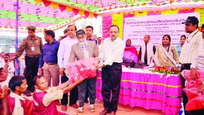 DINAJPUR: Minister for Primary and Mass Education Adv Md Mostafizur Rahman Fizar MP distributing clothes among Ansar and VDP members at Partepur Upazila Parishad premises organised by Feed Office of Muslim Aid Bangladesh on Saturday.