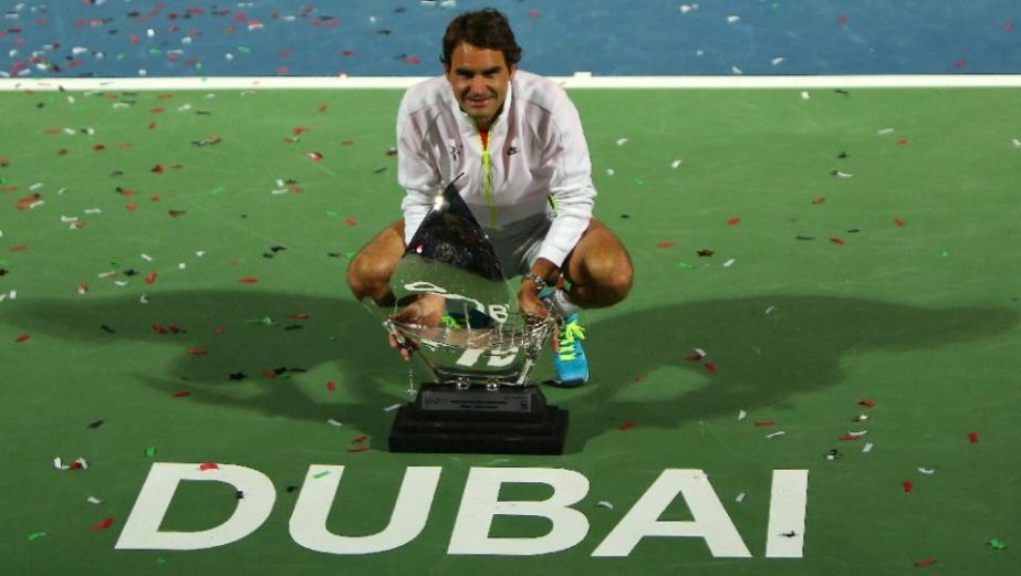 Roger Federer of Switzerland poses with the ATP Dubai Duty Free Tennis Championships trophy after defeating World number one Novak Djokovic of Serbia on Saturday