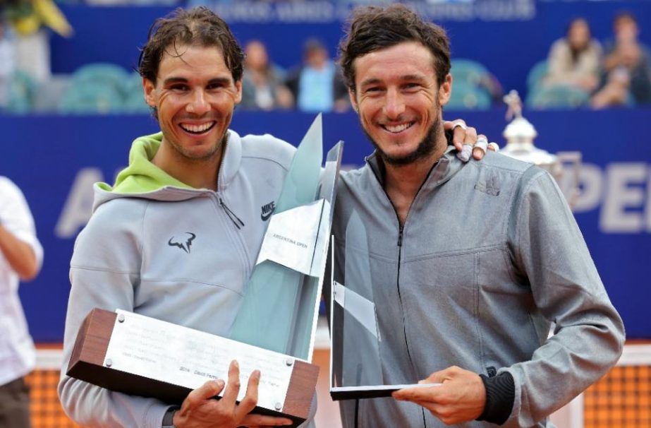 Rafael Nadal (L) and Juan Monaco with their Argentina Open trophies in Buenos Aires on Sunday.