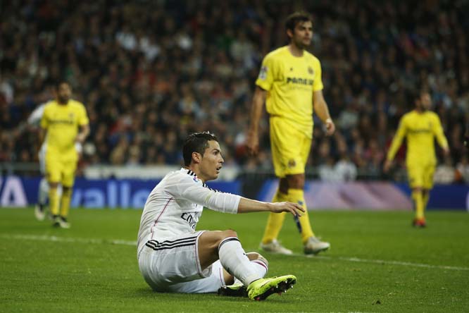 Real Madrid's Cristiano Ronaldo, foreground gestures during a Spanish La Liga soccer match between Real Madrid and Villarreal at the Santiago Bernabeu stadium in Madrid, Spain on Sunday.