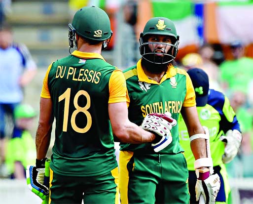 South Africa's Hashim Amla (R) and teammate Faf du Plessis (L) celebrate their combined century during the Cricket World Cup Pool B match between Ireland and South Africa in Canberra on Tuesday.