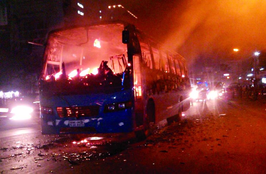 A passenger bus of Kanak Paribahan set afire by hartal supporters in city's Uttara area on Tuesday night.