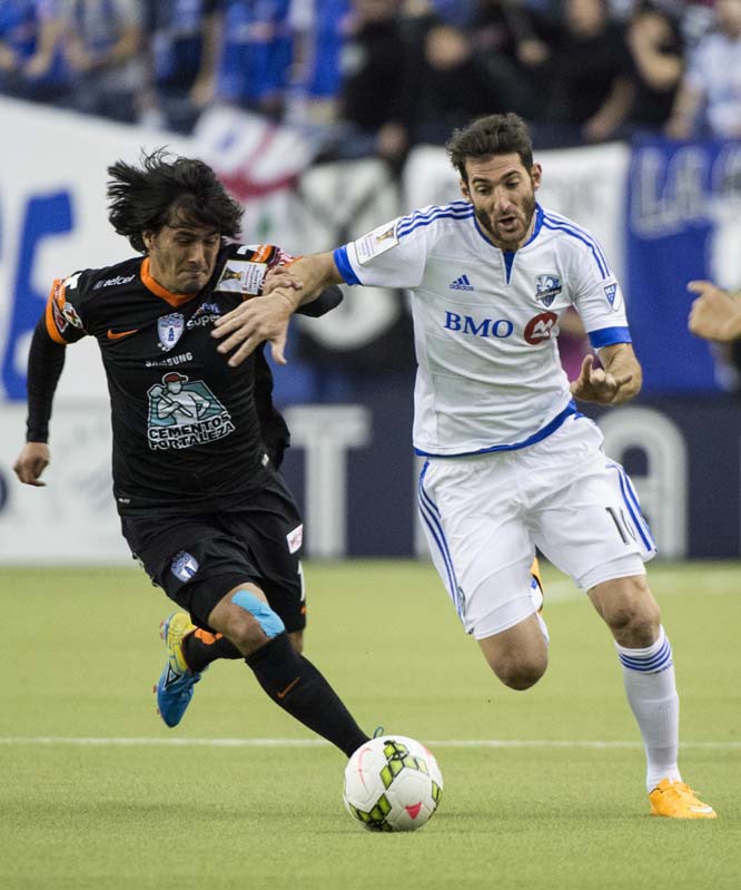 Pachuca's Jorge Hernandez (left) and Montreal Impact's Ignacio Piatti run for the bal during the first half of a CONCACAF soccer match on Tuesday in Montreal.