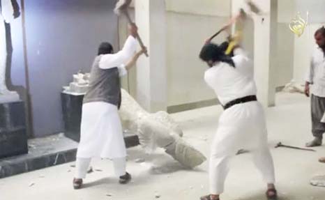 Islamic State militants destroying a statue of an Assyrian diety in the Iraqi Governorate of Nineveh.
