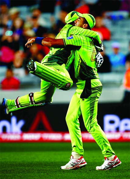 Sarfraz Ahmed leaps into Wahab Riaz's arms after JP Duminy was dismissed during the 2015 ICC Cricket World Cup match between South Africa and Pakistan at Eden Park in Auckland, New Zealand on Saturday.