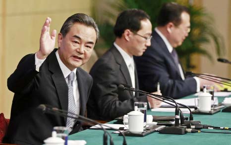 Chinese Foreign Minister Wang Yi gestures as he speaks at a news conference at the annual session of the National People's Congress (NPC), the country's parliament, in Beijing on Sunday.