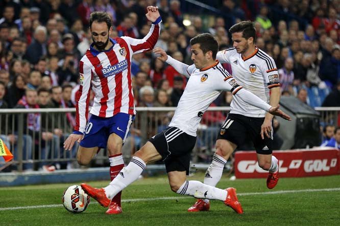 Atletico de Madridâ€™s Juan Fran (left) duels for the ball with Valencia's Jose Gaya during a Spanish La Liga soccer match between Atletico de Madrid and Valencia at the Vicente Calderon stadium in Madrid, Spain on Sunday.