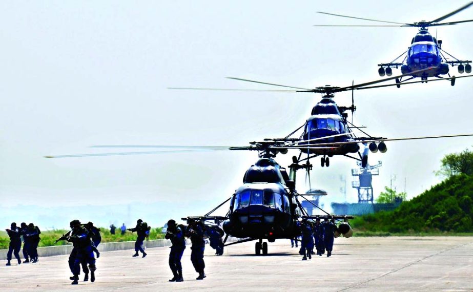 Commando soldiers are seen attacking enemy troops landing from MI-171 helicopters during 'Wintex -2015', the annual winter exercise of Bangladesh Air Force, on Monday. The exercise was held simultaneously at all air force bases across the country.