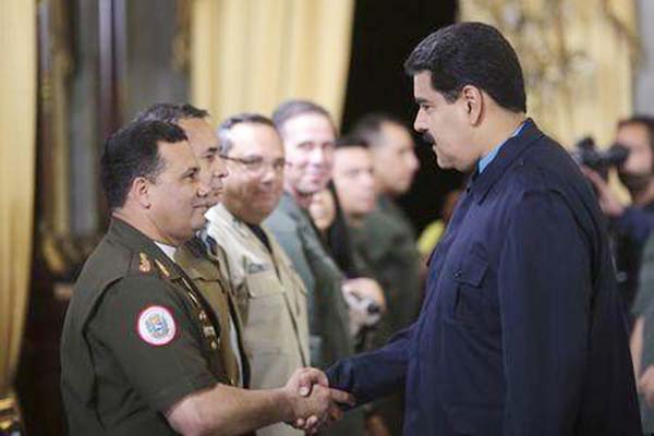 Venezuela's President Nicolas Maduro Â® greets Gustavo Gonzalez as he welcomes army members sanctioned by the U.S. during a national TV broadcast in Caracas.