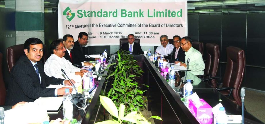 Ashok Kumar Saha, Chairman of the Executive Committee of the Board of Directors of Standard Bank Limited, presiding over the 121st meeting of the committee in the city on Monday. Managing Director and CEO Md Nazmus Salehin and DMD Mamun- Ur- Rashid of the