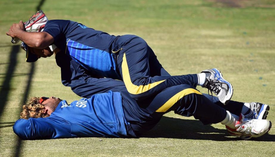 A support staff helps Sri Lanka cricketer Lasith Malinga to stretch his muscles during a training session at the Bellerive Oval ground ahead of the 2015 Cricket World Cup Pool A match between Scotland and Sri Lanka at Hobart on Tuesday.