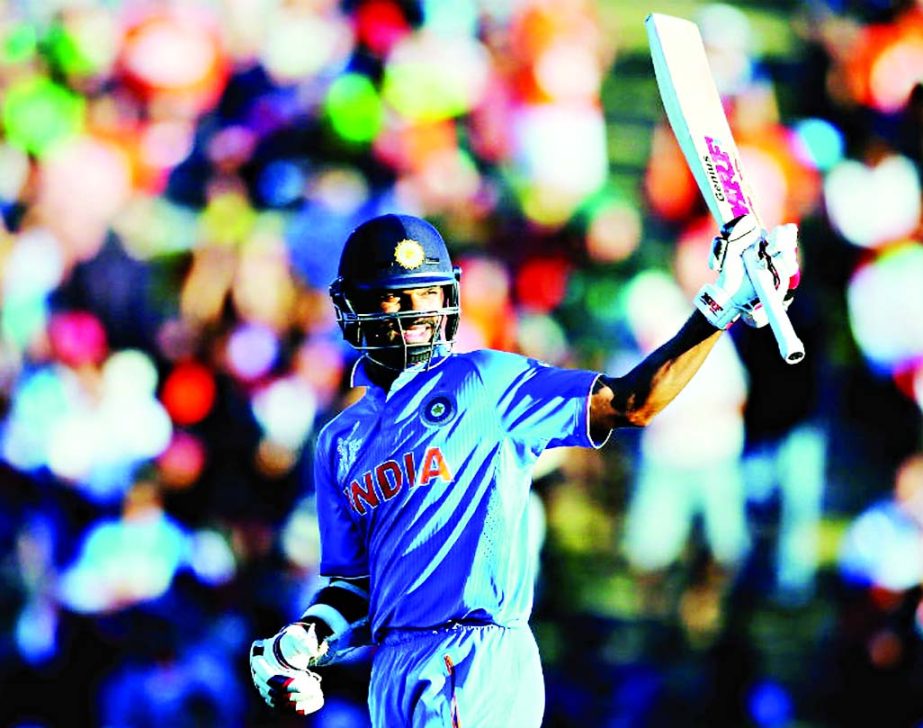 India's Shikhar Dhawan raises his bat after his fifty against Ireland in World Cup Group B match at Hamilton on Tuesday.