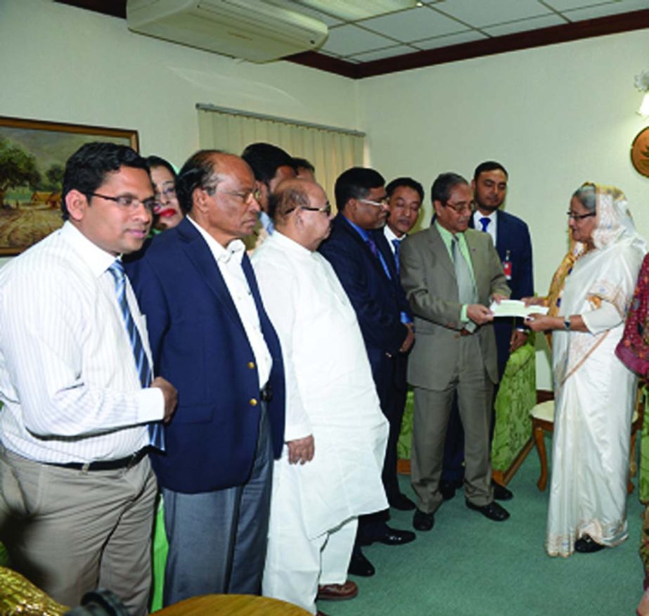 Prime Minister Sheikh Hasina, receiving a cheque of Tk 50, 00,000 for her relief fund for arson victims' treatment from Sheikh Kabir Hossain, President, Bangladesh Insurance Association at her office on Thursday. Ahasanul Islam Titu, Vice-President, Memb