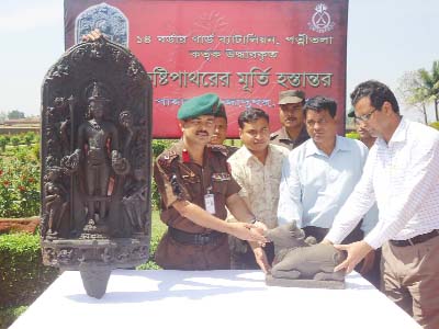 NAOGAON: Members of 14 BGB handing over two touches stone made statues to Paharpur Museum on Tuesday.
