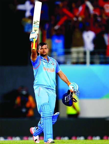 Suresh Raina celebrates his maiden World Cup century during the ICC Cricket World Cup match between India and Zimbabwe at Eden Park in Auckland, New Zealand on Saturday.