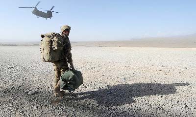 US solider stands guard at the site of a suicide attack near a U.S. military camp in Kabul.