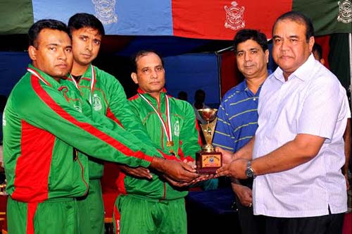 Assistant Chief of Air Staff (Operation and Training) Air Vice marshal Abu Esrar giving away champion trophy to BAF Base Bashar team who won the title of BAF Inter-Base Squash Competition at BAF Base Bashar, Dhaka Cantonment on Monday.