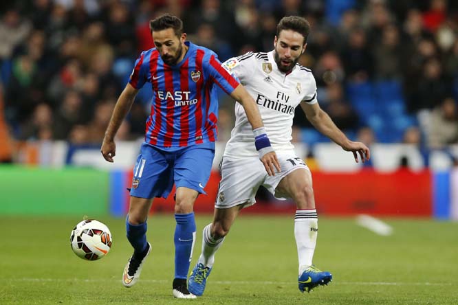 Real Madrid's Daniel Carvajal (right) duels for the ball with Morales during a Spanish La Liga soccer match between Real Madrid and Levante at the Santiago Bernabeu stadium in Madrid, Spain on Sunday.