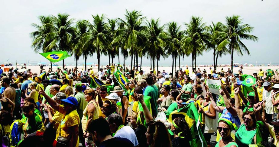 People march to protest the government of Brazil's President Dilma Rousseff along Copacabana beach in Rio de Janeiro, Brazil.