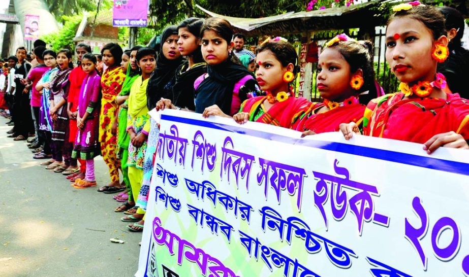 Marking the National Children's Day 'Oporajeo Bangladesh' formed a human chain infront of the Jatiya Press Club on Tuesday to ensure children's rights.