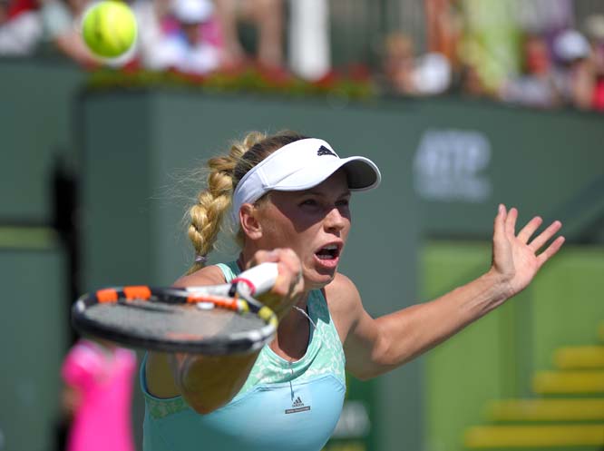 Caroline Wozniacki of Denmark returns a volley against Belinda Bencic of Switzerland during their match at the BNP Paribas Open tennis tournament in Indian Wells, Calif on Monday.