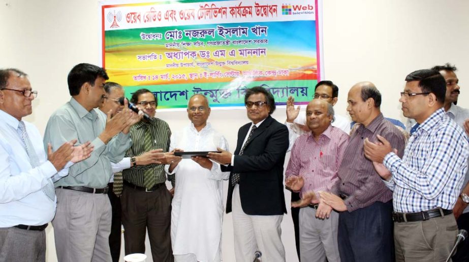 Education Secretary Md Nazrul Islam Khan is seen with others at the launching program of web radio and web television of Bangladesh Open University on Saturday.