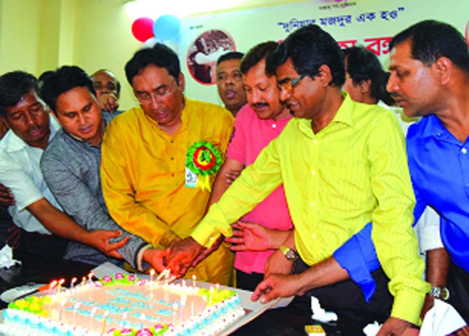 Board of Directors of Bangladesh Development Bank Ltd Quazi Murshed Hossain Kamal and Dr Rustom Ali Ahmed celebrating 95th birthday of the Father of the Nation Bangabandhu Sheikh Mujibur Rahman by cutting cake at bank's CBA office on Tuesday. Officers a