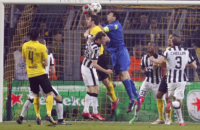 Juventus goalkeeper Gianluigi Buffon (center) makes a save during the Champions League round of 16 second leg soccer match between Borussia Dortmund and Juventus Turin in Dortmund, Germany on Wednesday.