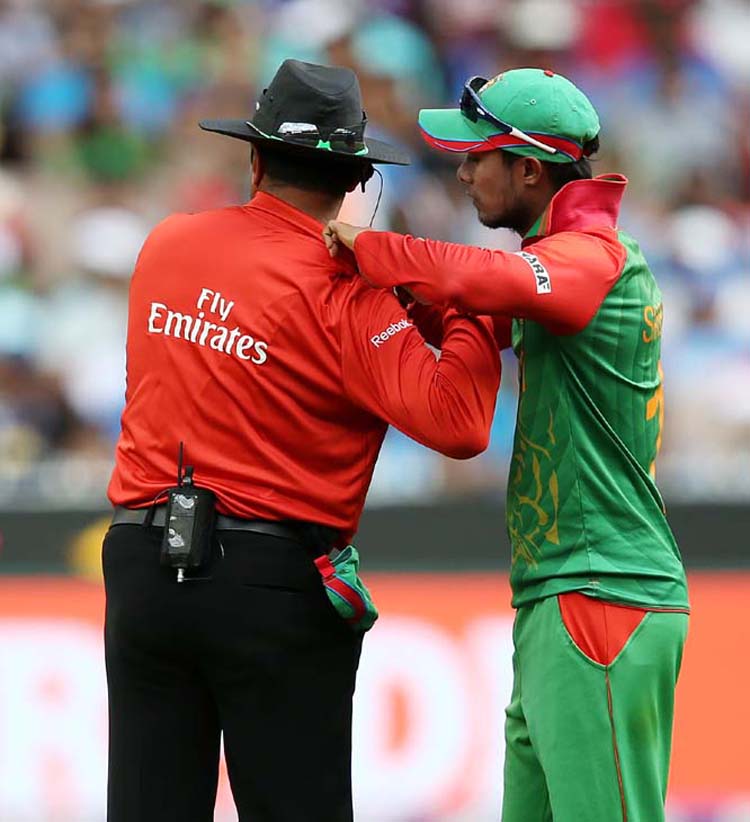 Bangladeshâ€™s Shabbir Rahman Roman (right) helps umpire Alam Dar during their Cricket World Cup quarterfinal match against India in Melbourne, Australia on Thursday.
