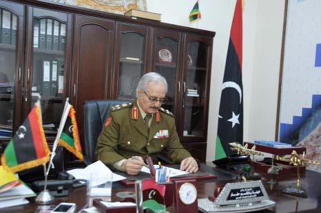 Gen. Khalifa Hifter, Libya's top army chief, works in his office during a visit by the Associated Press in al-Marj, Libya..
