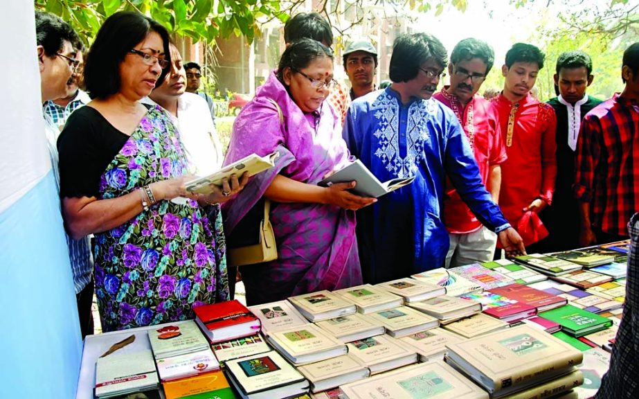 Vice-Chancellor of Jahangirnagar University (JU) Prof Dr Farzana Islam, among others, flip through the books at a stall of a 3-day Book Fair after inaugurating it on Saturday on JU campus.