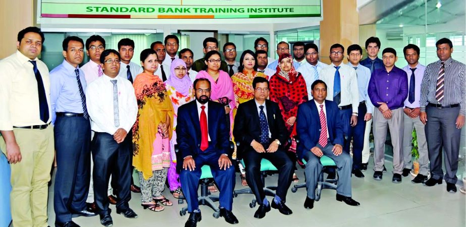 Nazmus Salehin, Managing Director and CEO of Standard Bank Limited, poses with trainees of a two-day training workshop on "Internal Control and Compliance" organised by Training Institute of the bank on Sunday. Md Zashim Uddin, Head of ICCD and Md Zakar