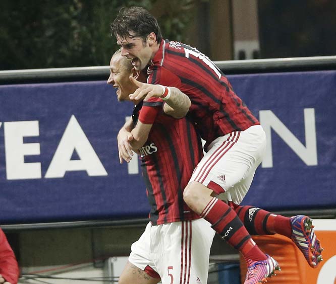 AC Milan's Philippe Mexes (left) celebrates with his teammate Andrea Poli after scoring during the Serie A soccer match between AC Milan and Cagliari at the San Siro stadium in Milan, Italy on Saturday.