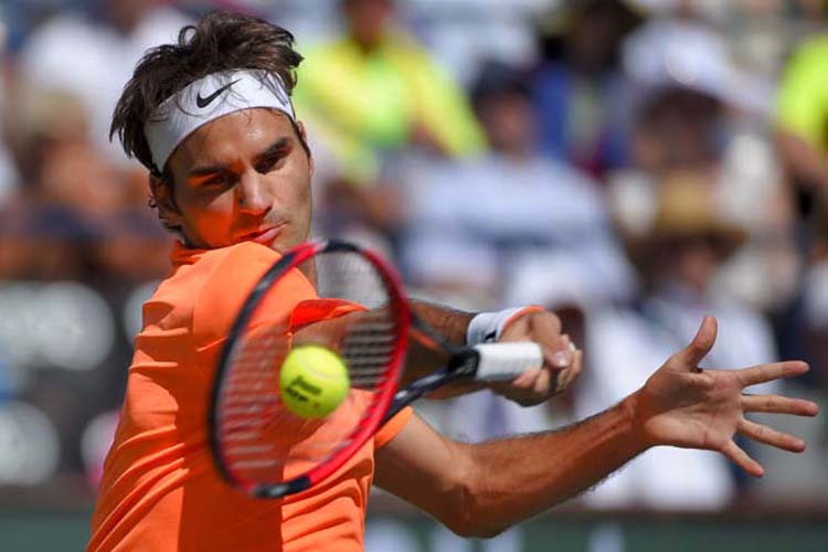 Roger Federer of Switzerland returns to Milos Raonic of Canada during their semifinal match at the BNP Paribas Open tennis tournament in Indian Wells, Calif on Saturday.